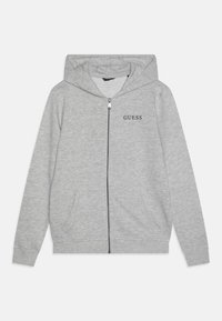Grey zip-up hoodie with a drawstring hood, front pockets, and black "GUESS" logo on the left chest. Made of soft fabric.