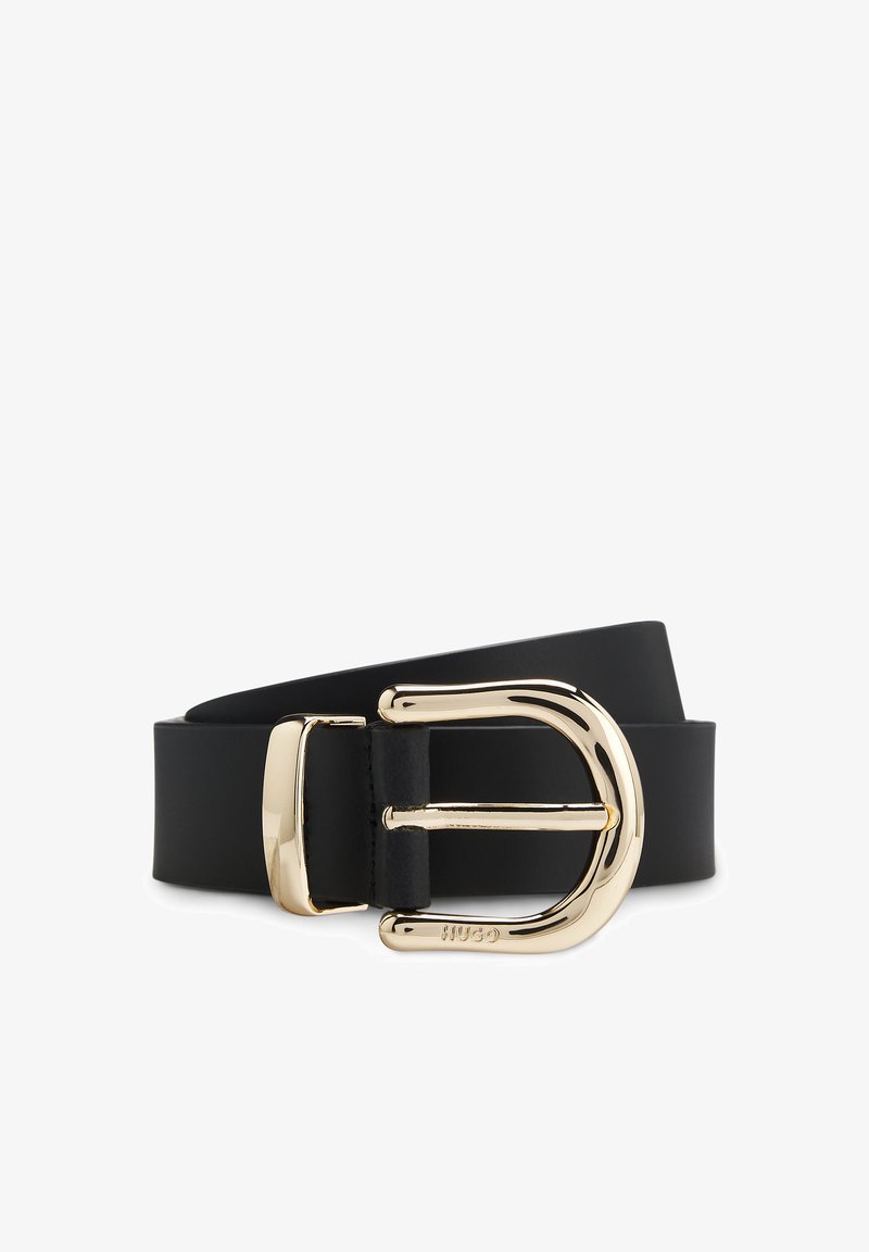 Mustavöinen vyö, joka on valmistettu kestävästä materiaalista, sisältää kiiltävän kultasävyisen D-muotoisen soljen, jossa on kaiverruksia ja sileä pinta.