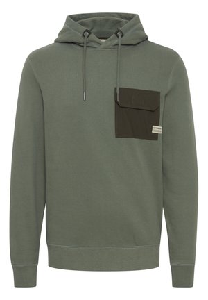Grüner Hoodie mit einer Kapuze, ausgestattet mit einer dunkelgrünen aufgesetzten Brusttasche und Kordeln. Hergestellt aus weichem, strukturiertem Material.