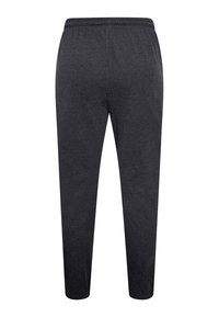 Charcoal gray jogger pants with an elastic waistband, tapered leg design, and soft fabric texture. No visible patterns or accents.