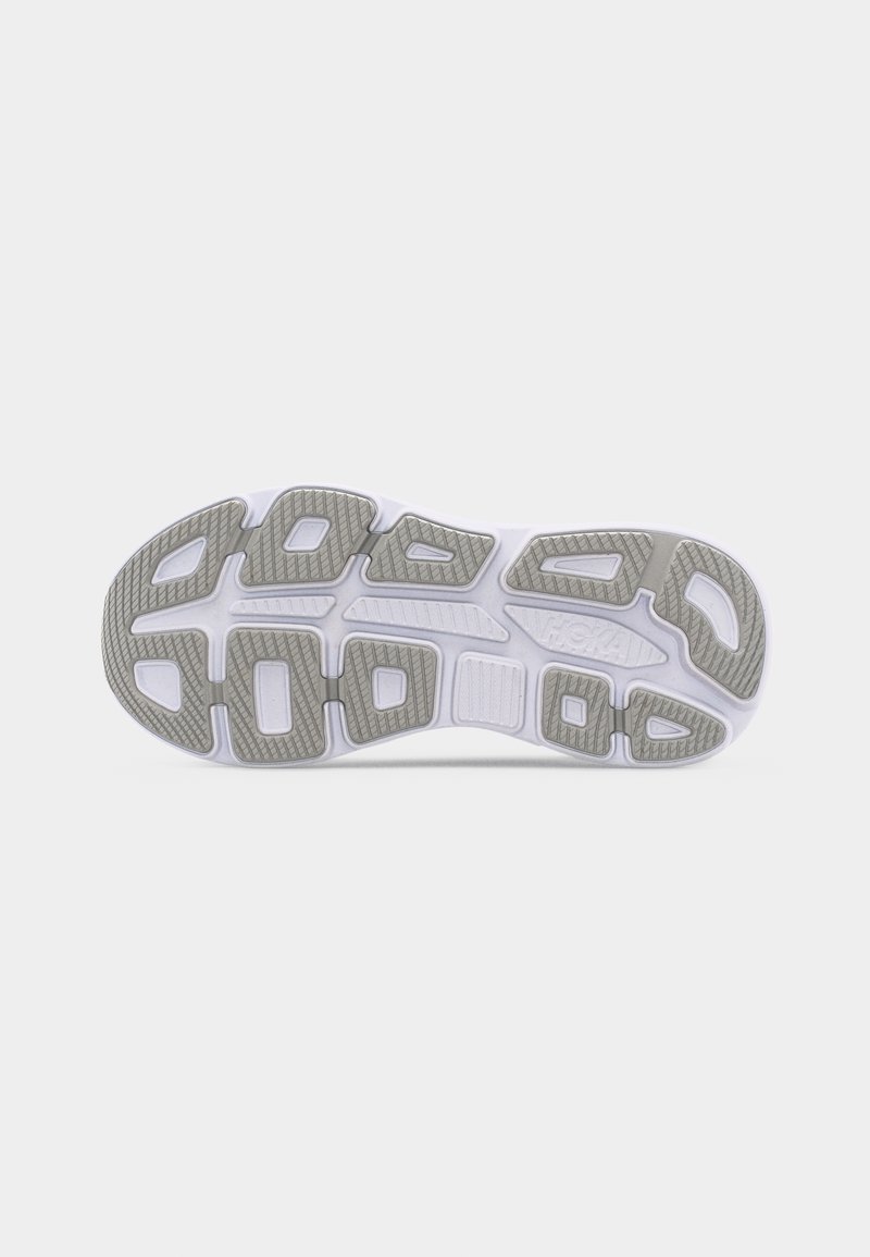 Schuhsohle mit weißer Basis und grauen Gummiprofilabschnitten, die geometrische Muster für Grip und Flexibilität aufweisen.