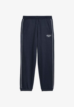 Navy sweatpants with white side stripes, elastic waistband, and drawstring. Features printed text: "1989 Hudson Baseball Dept NYC."