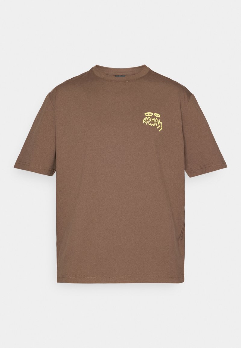 Brown short-sleeve T-shirt with crew neck and small yellow abstract logo on the left chest reading "KARMA" with eye shapes above.