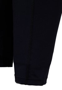 Schwarze Sportleggings mit glatter Textur, elastischem Stoff und genähten Nähten entlang der Seiten und des Saums für Langlebigkeit.