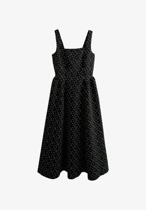Čierne šaty s hranatým výstrihom a širokými ramienkami, s rozšírenou sukňou. Ozdobené bielymi bodkami po celom povrchu. Bavlnená látka.