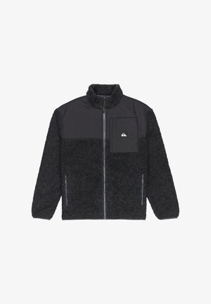 Veste en polaire noire avec un haut en nylon noir lisse, fermeture à demi-zip sur le devant, col haut, poche sur la poitrine et poches latérales zippées.