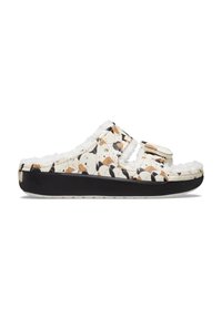 Chaussons blancs avec motifs de chiens, doublure en peluche et semelle noire. Comprend une sangle ajustable et une semelle en caoutchouc texturée.