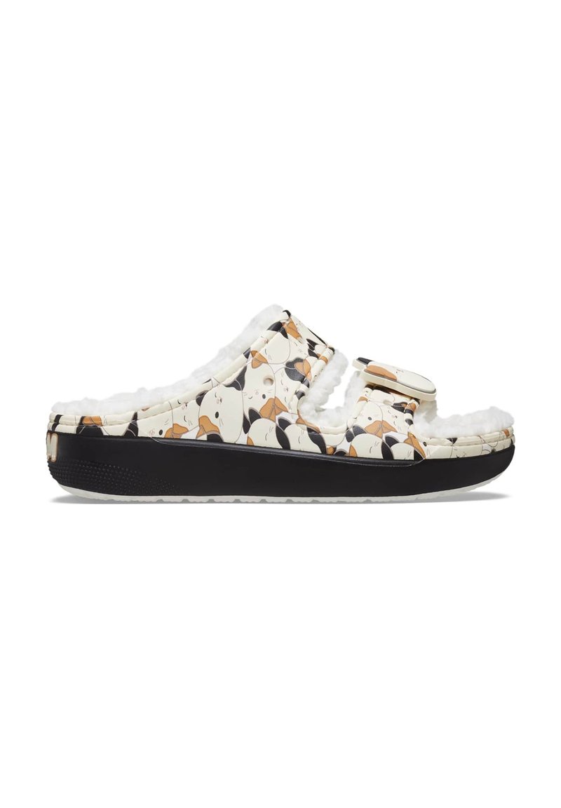 Chaussons blancs avec motifs de chiens, doublure en peluche et semelle noire. Comprend une sangle ajustable et une semelle en caoutchouc texturée.