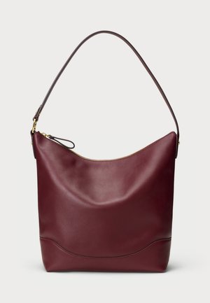 Burgunderfarbene Leder-Umhängetasche mit einer geschwungenen Oberseite, goldener Reißverschluss und einem einzelnen dunklen Trageriemen. Sie hat eine glatte, weiche Textur und ein minimalistisches Design.