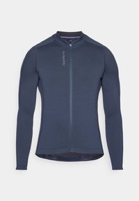 Garās piedurknes velosipēdu krekls tumši zilā krāsā, ar pilnu priekšējo rāvējslēdzēju, teksturētu audumu un atstarojošiem akcentiem. Augsts apkakle ar ergonomiskām šuvēm.