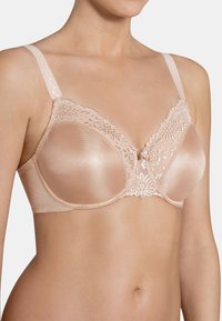 Beige beha met gladde stoffen cups en bloemenkantdetails aan de bovenkant. Verstelbare banden met decoratieve accenten. Ondersteuning met baleinen inbegrepen.