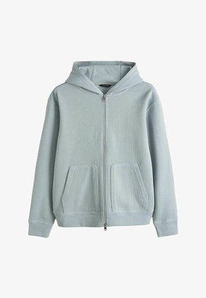 Hellblauer, gerippter Kapuzenpullover mit Reißverschluss, Fronttaschen und langen Ärmeln vor weißem Hintergrund.