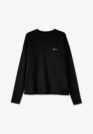 Sweatshirt preto de manga longa com um padrão texturizado de malha waffle. Apresenta um decote redondo e um pequeno logotipo branco em destaque no peito.