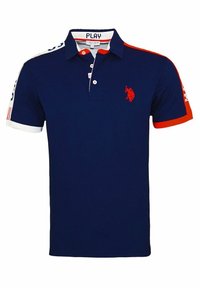 Navy blue polo shirt made of cotton with red and white accents, featuring a three-button placket and embroidered logo on the chest.