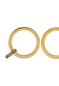 Kolczyki z metalu o złotym odcieniu w kształcie koła, z jednym małym akcentem z pięcioma ciemnymi kamieniami ułożonymi w linii. Gładka faktura.
