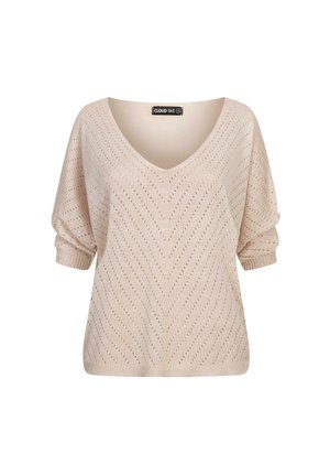 Lett V-hals genser i lys beige med åpen arbeid zigzag mønster, korte ermer og ribbede mansjetter. Myk tekstur.