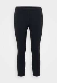 Leggings sportivi neri con una texture liscia, forma aderente e cuciture in contrasto, dotati di un logo sulla parte inferiore della gamba e una vita a media altezza.
