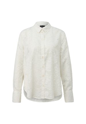 Camicia bianca a manica lunga con bottoni, con una sottile trama floreale, colletto a punta e orlo arrotondato, mostrata su uno sfondo neutro.