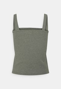 Grön randig linne med justerbara band, med en åtsittande silhuett och mjuk textur, utformad för komfort och mångsidighet.