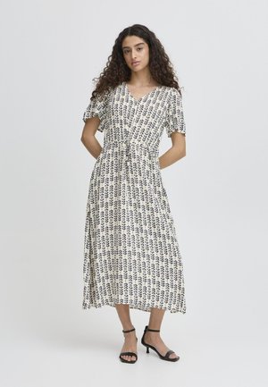 Floral-patterned midi dress in cream and navy, featuring a V-neck, short puff sleeves, and a fitted waist with a tie detail.