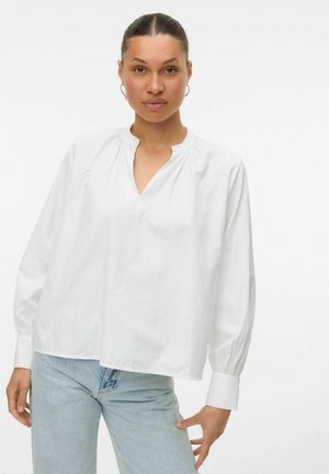 White long-sleeve blouse with a V-neck and pintuck details. Made of lightweight fabric, featuring a relaxed fit and buttoned cuffs.
