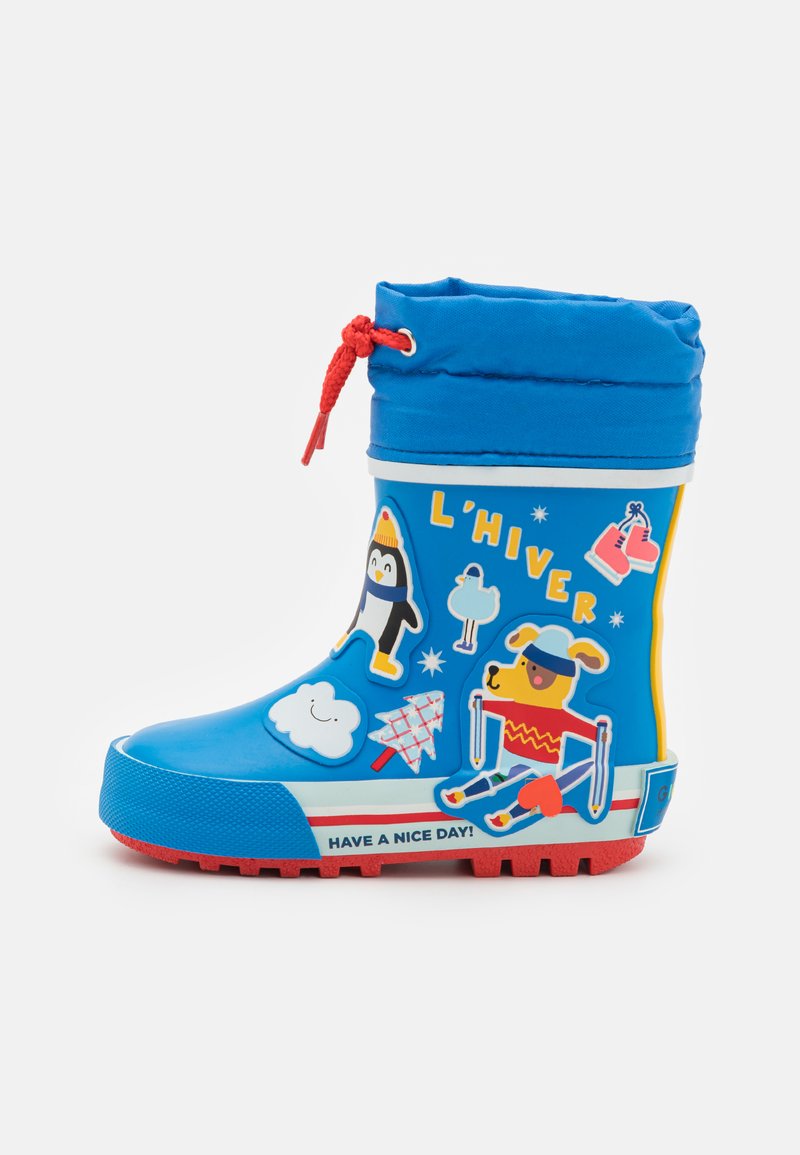 Sinine kummikäsi, millel on pehme sinine tekstiilserv, punased aktsendid ja mitmed lõbusad joonistused, sealhulgas pingviin ja koer.