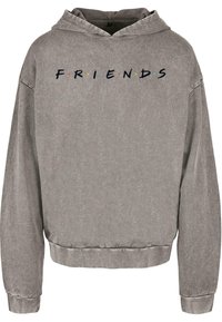 Šedá mikina s kapucí, která má krátký střih a nápis "FRIENDS" s barevnými tečkami. Vyrobena z měkké, texturované tkaniny s dlouhými rukávy.