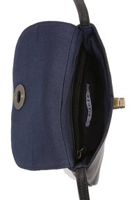 Navy canvas crossbody bag with black leather accents, magnetic closure, adjustable strap, and inner zip pocket. Labeled "PIECES."
