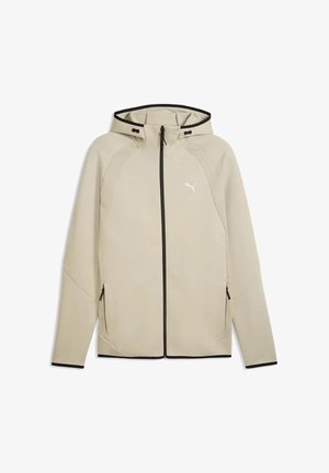 Veste à capuche beige avec fermeture éclair, garniture noire, poches latérales zippées et petit logo blanc Puma sur la poitrine.