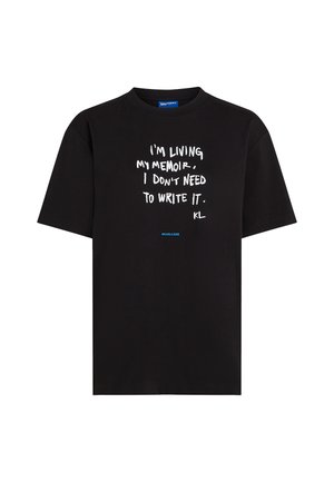 Black t-shirt made of cotton, featuring white text: "I'M LIVING MY MEMOIR, I DON'T NEED TO WRITE IT." Blue accent #KARLCORE at the bottom.