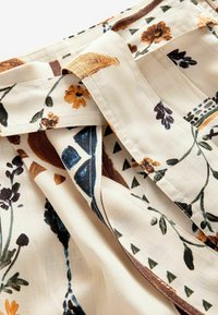 Next Tygbyxor - neutral sunflower print