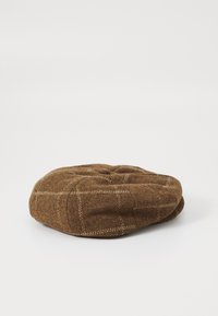 Brown wool beret with a tufted top, featuring a light check pattern and stitched accents around the edge.