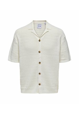 Cárdigan de manga corta y tejido abierto en color blanco roto, con un cuello en punta y seis botones redondos marrones en la parte delantera.