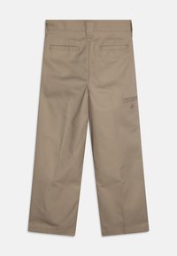 Pantalon en coton beige à coupe droite, avec deux poches arrière et une poche latérale. Design épuré avec des détails de couture visibles.