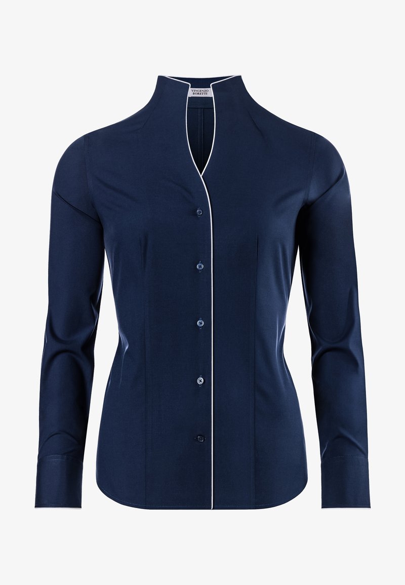Chemise bleu marine à manches longues avec un col montant, fermeture à boutons sur le devant, détails en piping blanc le long du col et des poignets, et texture de tissu lisse.