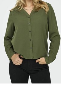 Green blouse with a v-neck and button front, made from lightweight fabric. Features long sleeves and a relaxed fit.