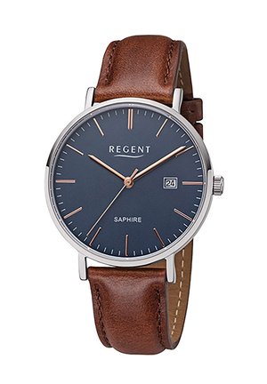 Montre analogique avec un cadran bleu marine, des index en or rose, un boîtier en argent et un bracelet en cuir marron. Présente un affichage de la date à 3 heures.