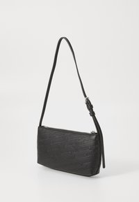 Black leather handbag featuring a textured design embossed with the brand name. It has a slim shape, adjustable strap, and zipper closure.