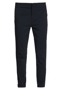 Slim-fit trousers in dark navy, made from smooth fabric. Features a flat front, standard waistband, and subtle side pockets.