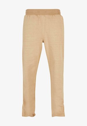 Pantaloni jogger beige realizzati in tessuto morbido, con una vita elasticizzata e gambe affusolate con cuciture laterali sottili per una vestibilità snella.