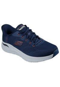 Scarpa sportiva blu navy con tomaia in mesh traspirante, suola intermedia bianca, lacci e sottili accenti rossi; presenta la tecnologia ArchFit per il supporto.