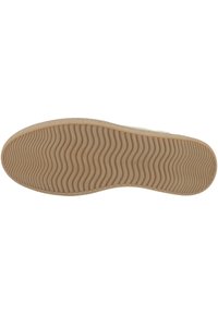 Sole of a shoe featuring a wavy tread pattern in light brown rubber, with a textured surface for grip and durability.
