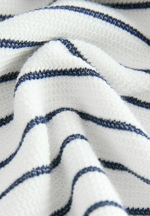 White fabric with navy blue horizontal stripes, featuring a soft, textured knit. The fabric drapes in gentle folds, showing its flexibility.