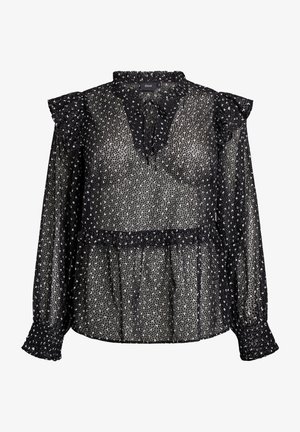Čierna, polopriehľadná blúzka s volánovým výstrihom a dlhými rukávmi. Má bodkovaný vzor a plisovaný pás, ktorý vytvára štruktúrovaný siluetu.