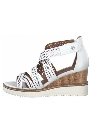 White wedge sandals with cut-out design, cork-like heel, and adjustable strap. Smooth texture with a rounded toe and rubber outsole.