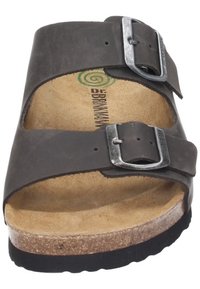 Black leather sandal with two adjustable straps, silver buckles, a cork footbed, and a non-slip black rubber sole.