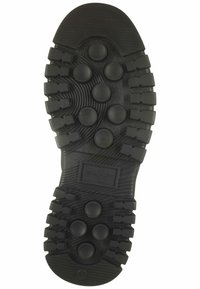 Black rubber shoe sole featuring a textured grip pattern with protruding circular and rectangular shapes, and embossed branding detail.