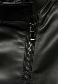 Black leather jacket with a smooth texture, featuring a vertical zipper and stitching details along the collar and side seams.