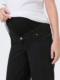 Jeans premaman neri con una fascia elastica sopra la pancia. Presentano tasche frontali e un classico design a cinque tasche. Il tessuto ha una texture morbida.