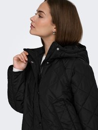 Black quilted jacket with a hood, featuring snap and zipper closures, diagonal stitching, and side pockets. Smooth texture, lightweight design.